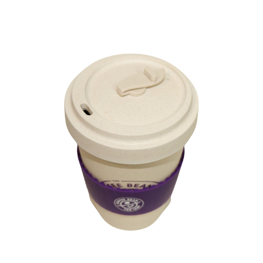 https://store.coffeebean.com/cdn/shop/products/bamboo_16oz_tumbler_with_purple_sleeve_and_no_drip_silicone_lid_top_folded_lid_900x.jpg?v=1669670056